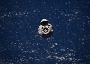 Dragon supply freighter docks at space station with 2.4 tons of cargo