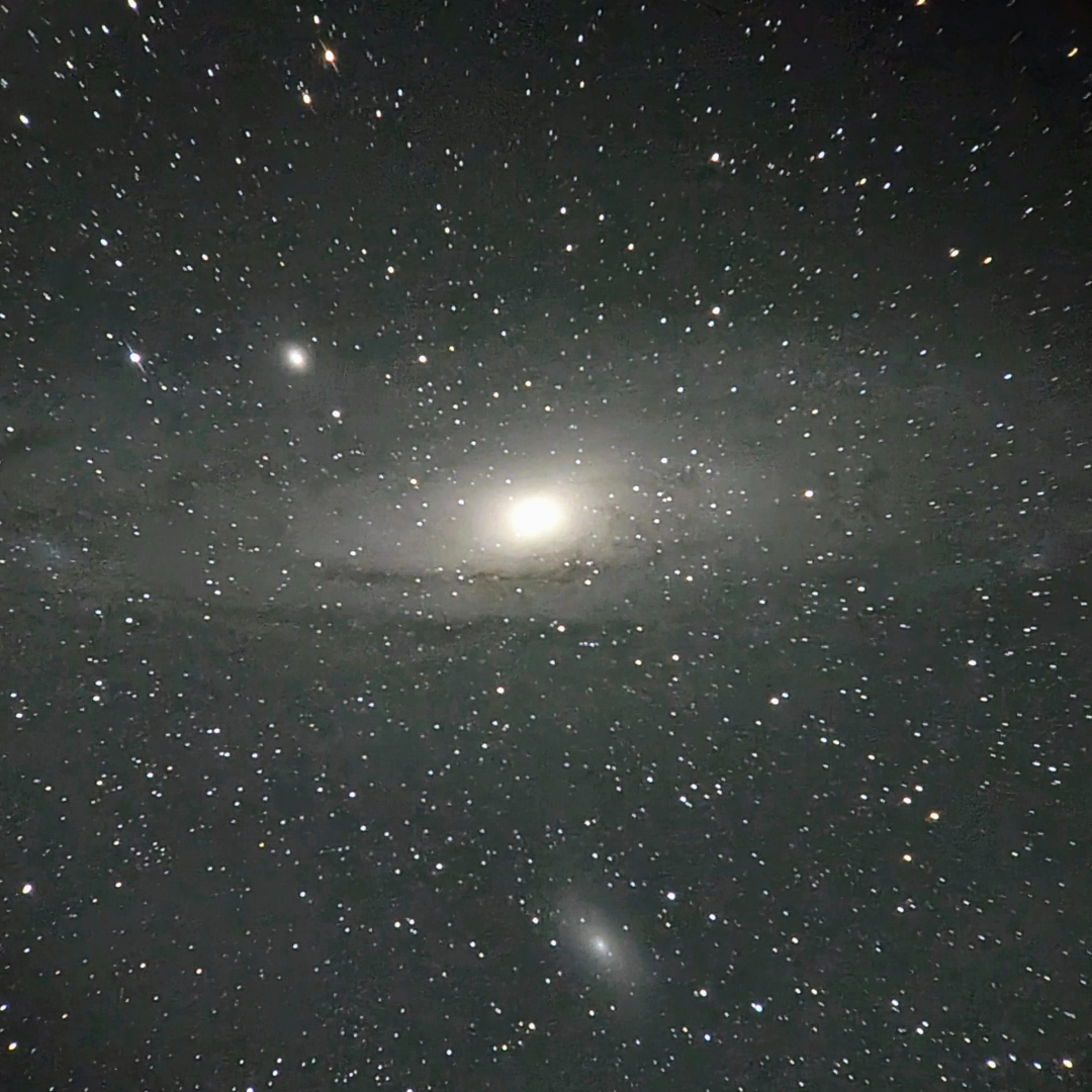 A picture of the Andromeda spiral galaxy pictured against a star-studded sky.