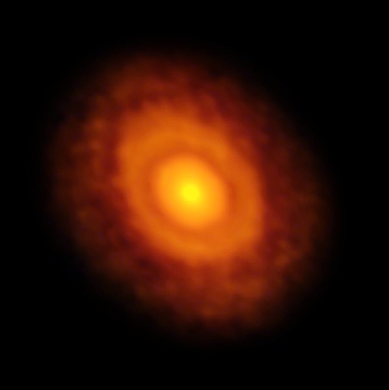 Glowing rings of light show a planet forming disk in the darkness of space