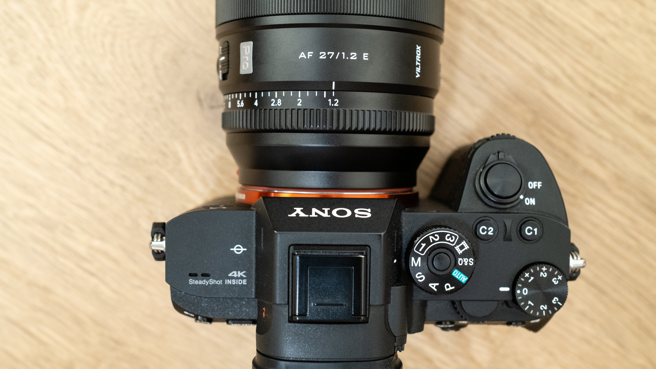 Viltrox AF 27mm f/ 1.2 Pro attached to a Sony A7R III on a wooden floor