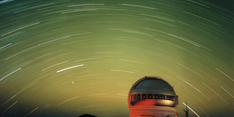 Star and satellite streaks in a green night sky | Space photo of the day for Nov. 12, 2025