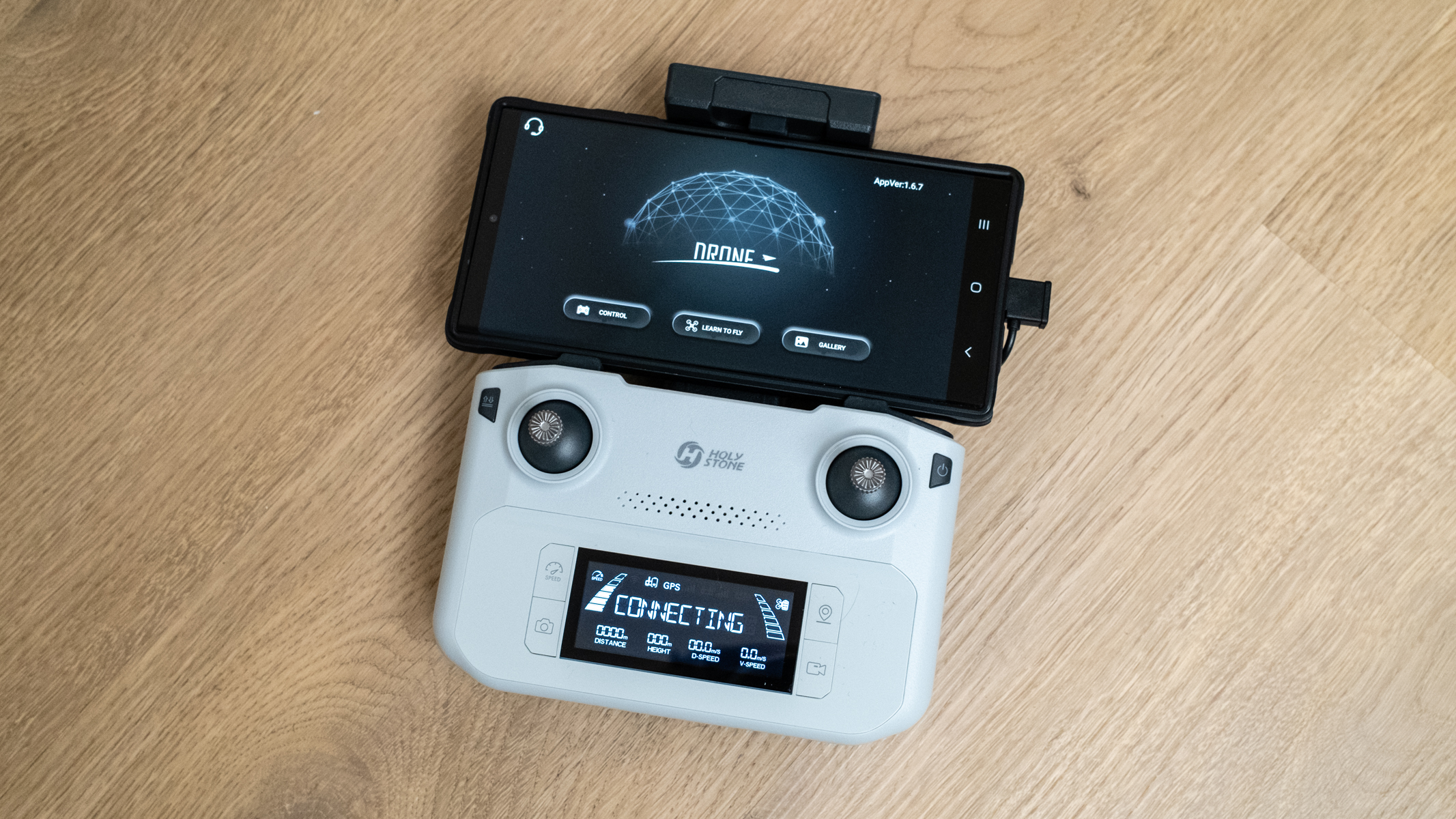 Holy Stone HS360E controller with smartphone attached and HS Fly app running