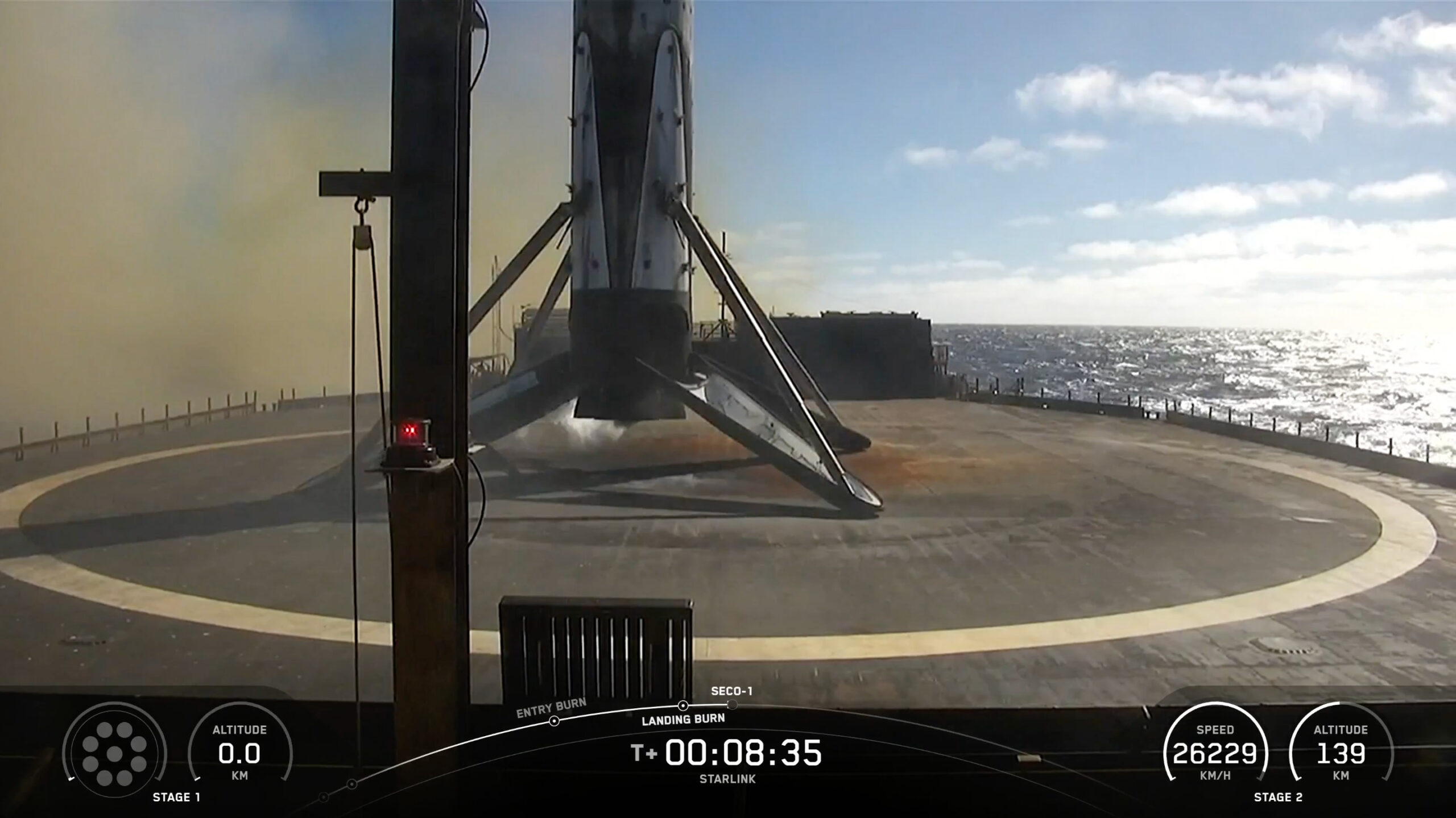 a black and white rocket rests on the deck of a ship at sea on a sunny day