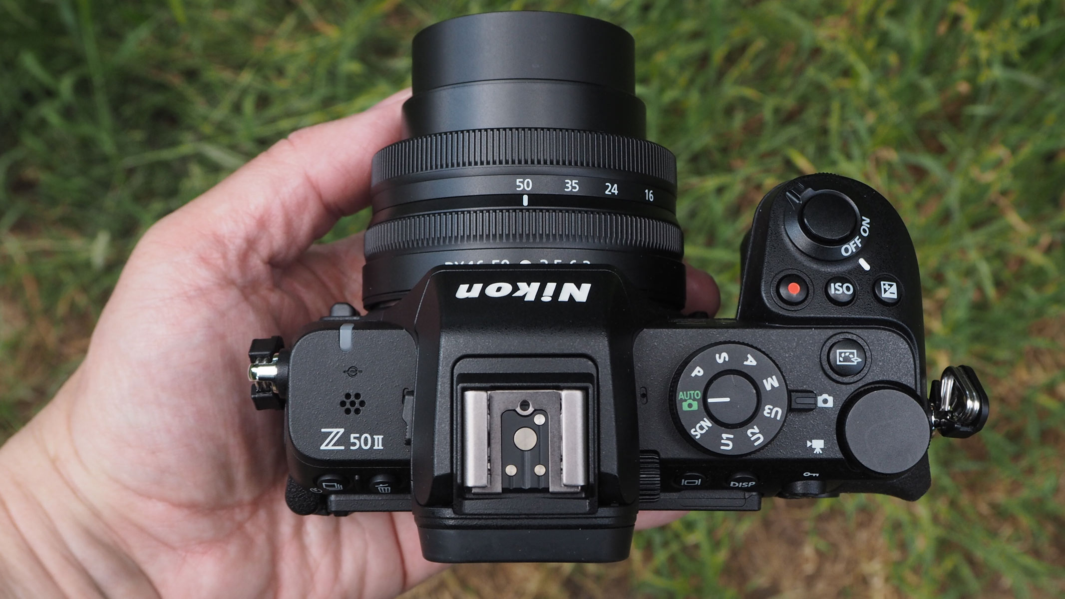 The controls of the Nikon Z50 II shown in a bird's eye view.