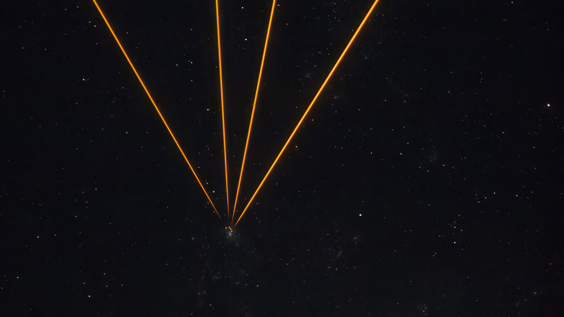 A series of golden lines converging to one point in a starry night in the center of the image