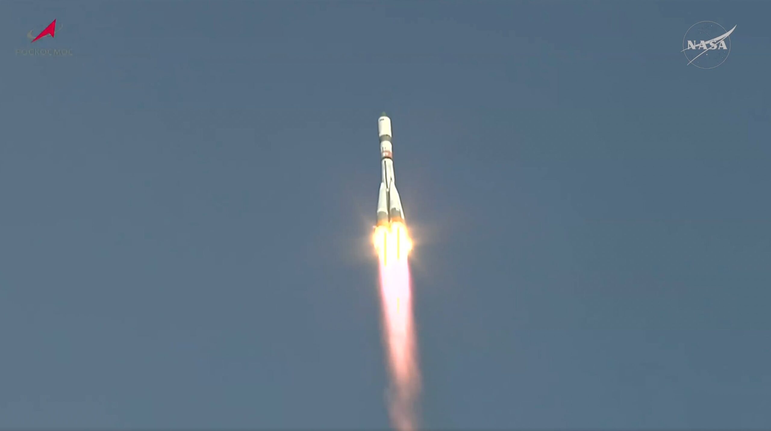 a white rocket climbs into a blue sky.