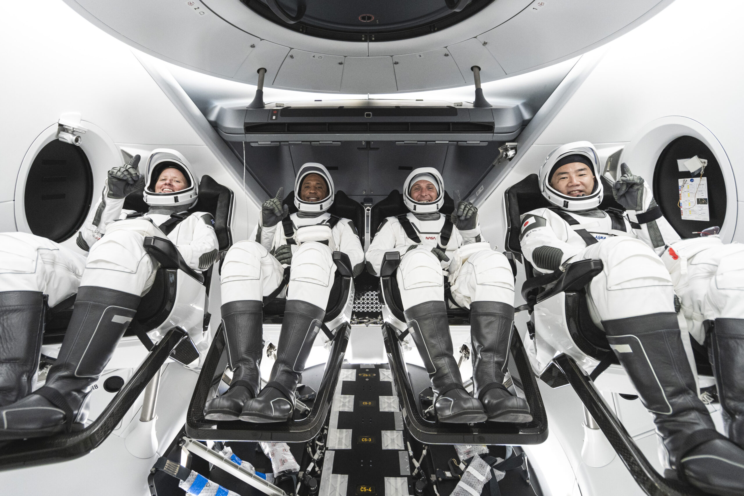 From left, Mission Specialist Shannon Walker, Pilot Victor Glover, Crew Dragon Commander Michael Hopkins &amp;ndash; all NASA astronauts &amp;ndash; and Japan Aerospace Exploration Agency (JAXA) astronaut and Mission Specialist Soichi Noguchi are seated in SpaceX&amp;rsquo;s Crew Dragon spacecraft during crew equipment interface training.