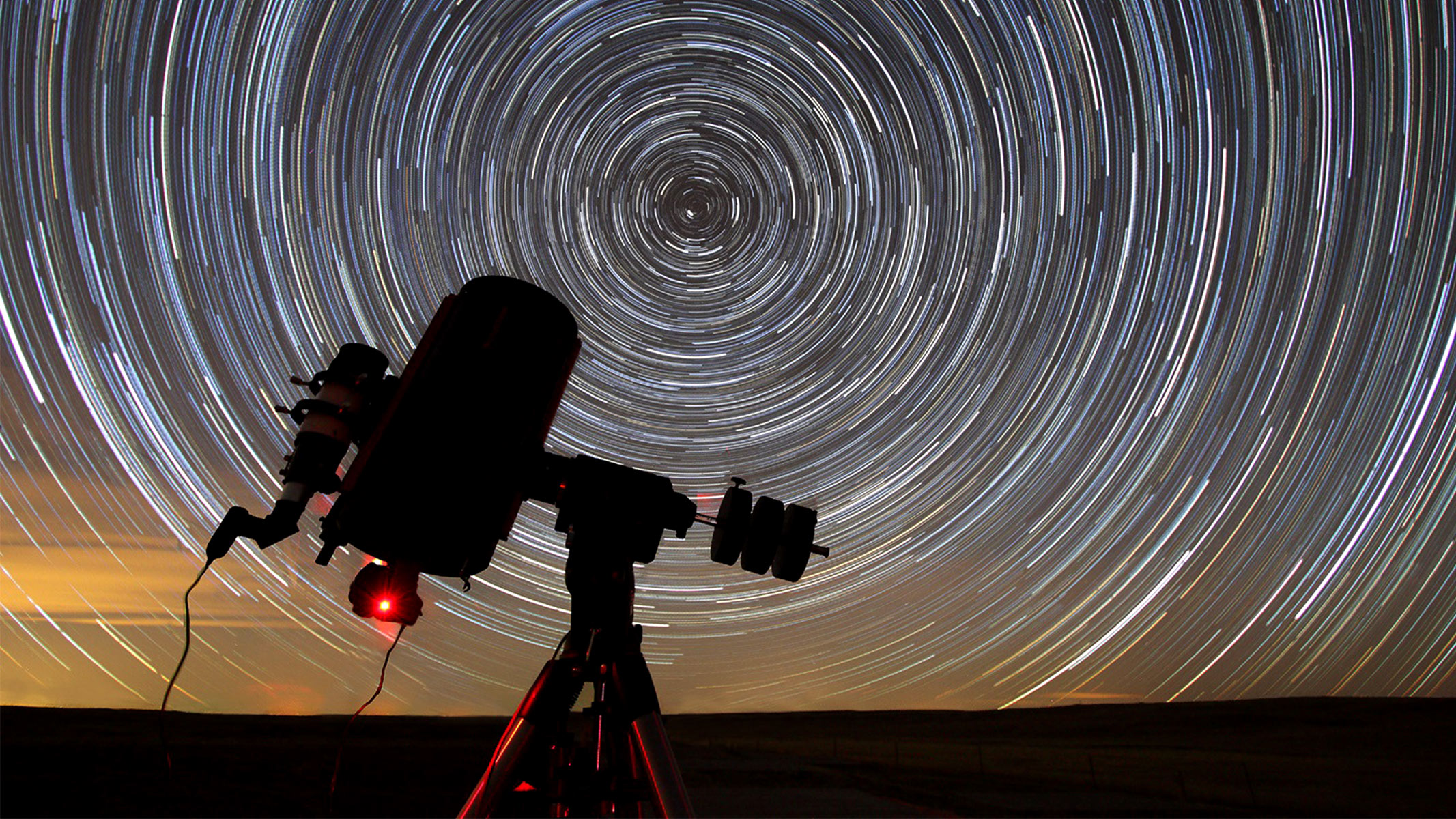 A telescope capturing a star trail.