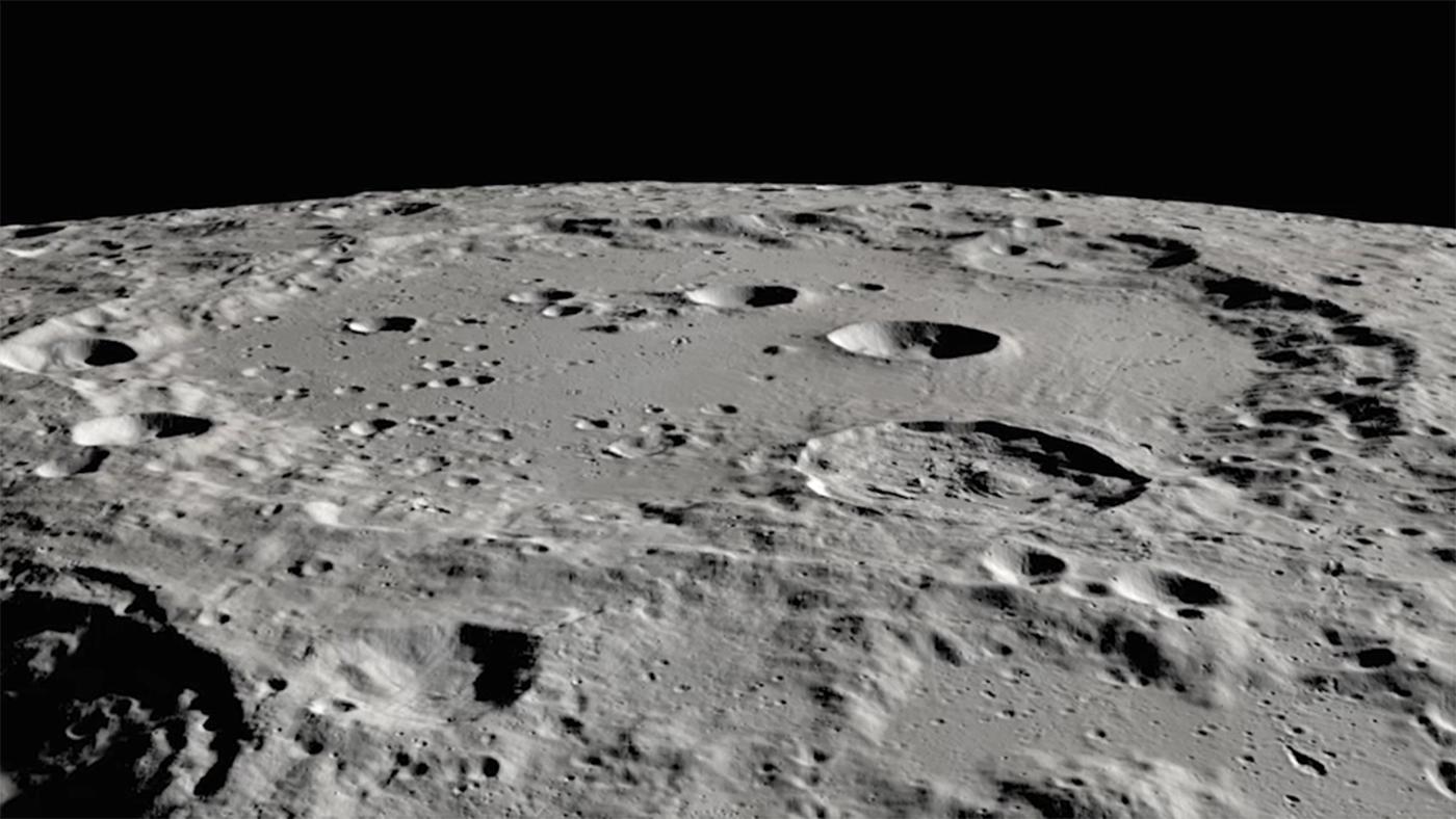 the grey cratered surface of the moon
