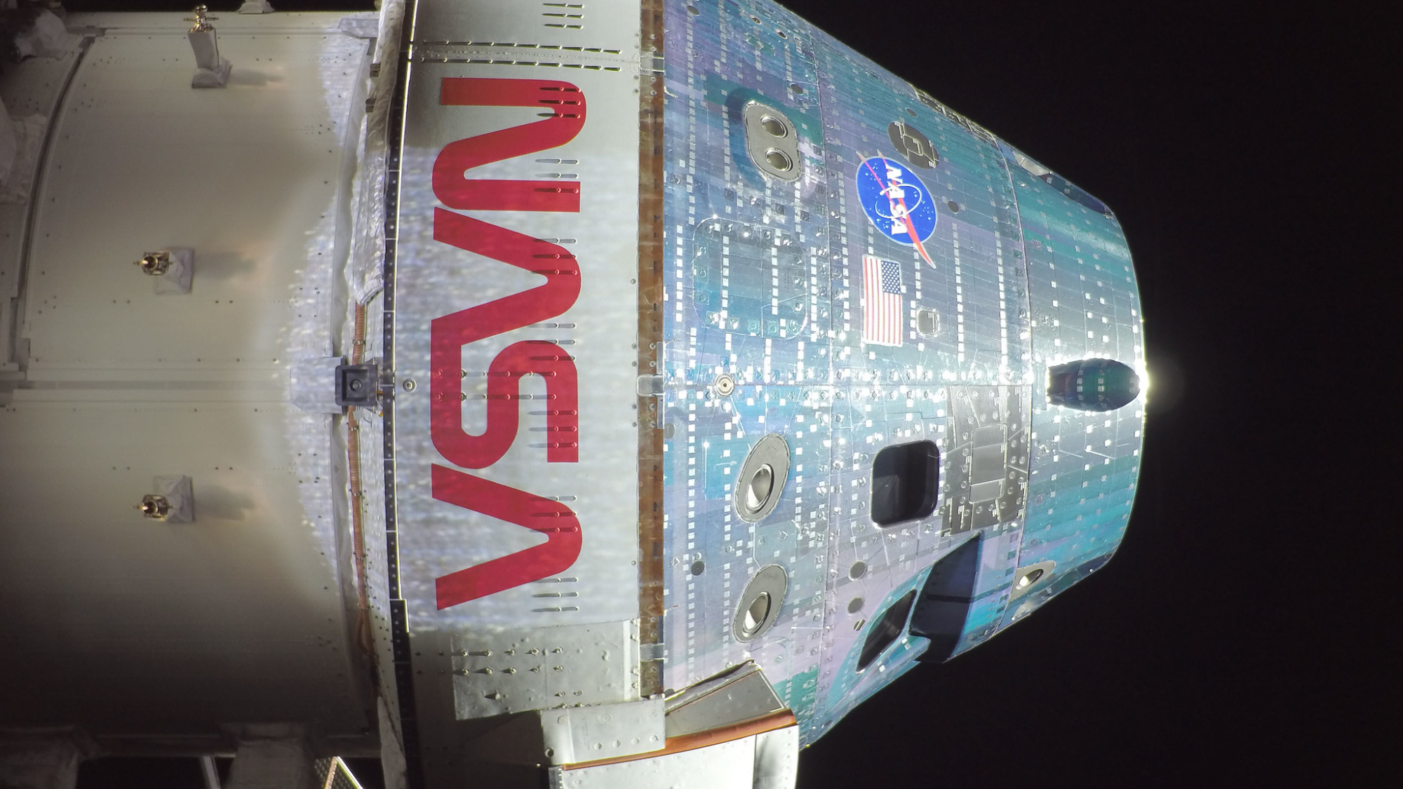 The Orion spacecraft with NASA logos visible on the way to the moon on Artemis 2